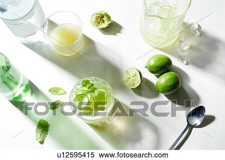 Stock Photography - Lime and soda cocktail preparation, overhead view. Fotosearch