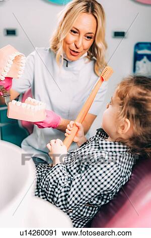 Little girl at dental clinic, learning how to brush teeth correctly. View Large Photo Image Stock Image - Little girl at dental clinic, learning how to brush teeth correctly.. Fotosearch