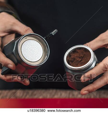 Stock Image - Making coffee with moka pot. Fotosearch