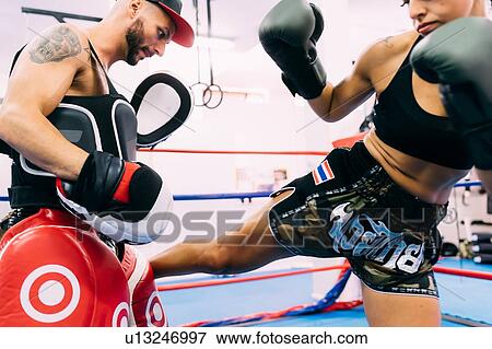 Male and female boxers working out in boxing ring View Large Photo Image Stock Photo - Male and female boxers working out in boxing ring. Fotosearch
