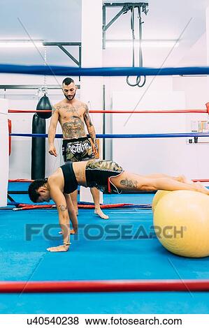 Stock Photo - Male and female boxers working out in boxing ring. Fotosearch