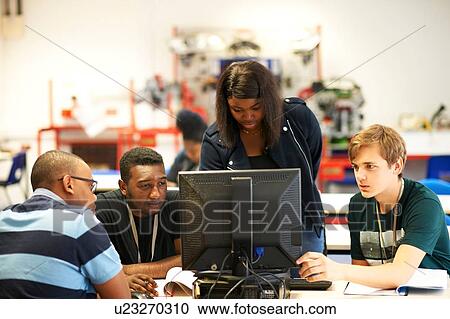 Male and female higher education students looking at computer in college classroom View Large Photo Image Stock Image - Male and female higher education students looking at computer in college classroom. Fotosearch
