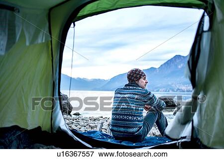 Man camping on lakeside, view from inside tent, Onno, Lombardy, Italy View Large Photo Image Stock Photo - Man camping on lakeside, view from inside tent, Onno, Lombardy, Italy. Fotosearch