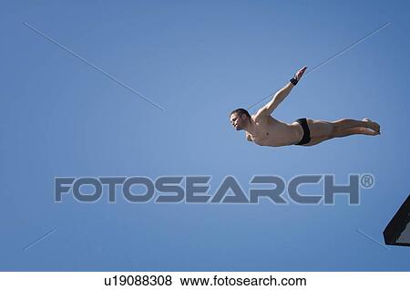 Stock Photo - Man diving from 10 meter platform. Fotosearch