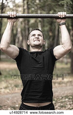 Picture - Man doing pull ups. Fotosearch
