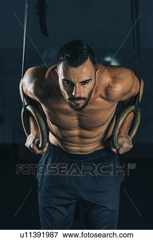 Man exercising on gymnastic rings View Large Photo Image Stock Photo - Man exercising on gymnastic rings. Fotosearch