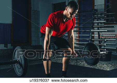 Stock Photo - Man lifting weights. Fotosearch
