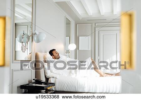 Man relaxing in suite View Large Photo Image Stock Photo - Man relaxing in suite. Fotosearch
