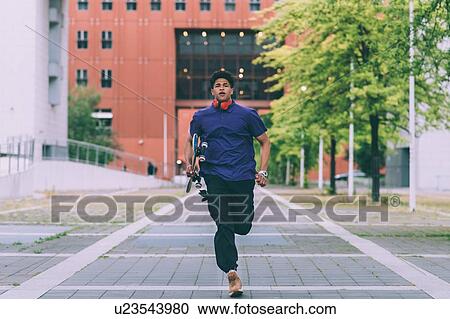 Stock Image - Man running, Milan, Italy. Fotosearch