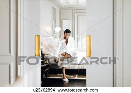 Picture - Man wearing bedroom slipper in suite. Fotosearch