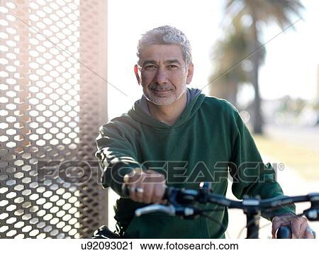 Stock Image - Man with bicycle enjoying sunny day, Melbourne, Victoria, Australia. Fotosearch