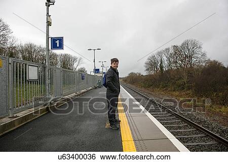 Stock Photograph - Man with down syndrome on platform in train station, Galway, Ireland. Fotosearch
