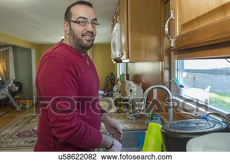 Man with visual impairment at his sink View Large Photo Image Stock Image - Man with visual impairment at his sink. Fotosearch