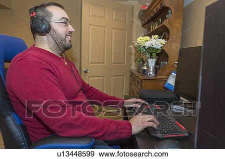 Stock Photo - Man with visual impairment using a screen reader. Fotosearch
