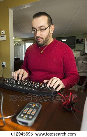 Stock Photography - Man with visual impairment using a screen reader. Fotosearch