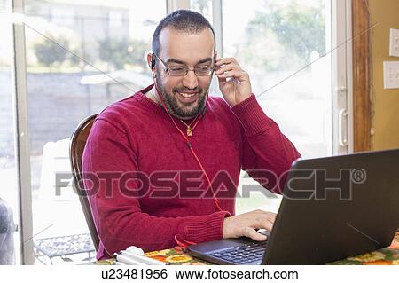 Stock Photograph - Man with visual impairment using his computer. Fotosearch