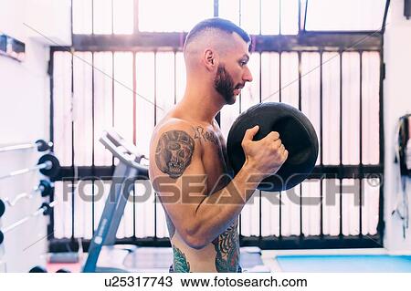 Man working out in gym View Large Photo Image Stock Image - Man working out in gym. Fotosearch