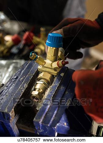 Man working with metal fitting View Large Photo Image Stock Photo - Man working with metal fitting. Fotosearch