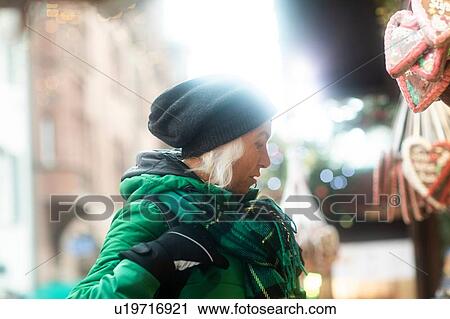 Mature woman shopping at Weihnachtsmarkt, Freiburg, Baden-Wurttemberg, Germany View Large Photo Image Stock Image - Mature woman shopping at Weihnachtsmarkt, Freiburg, Baden-Wurttemberg, Germany. Fotosearch