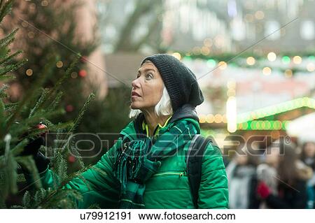 Mature woman shopping at Weihnachtsmarkt, Freiburg, Baden-Wurttemberg, Germany View Large Photo Image Stock Image - Mature woman shopping at Weihnachtsmarkt, Freiburg, Baden-Wurttemberg, Germany. Fotosearch