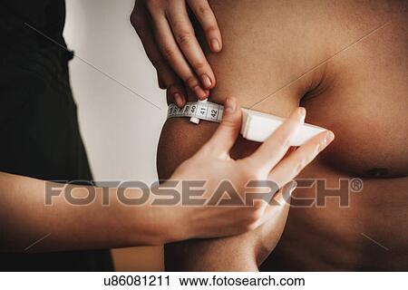 Measuring arm circumference View Large Photo Image Stock Image - Measuring arm circumference. Fotosearch