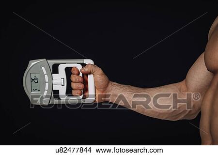 Measuring grip strength with dynamometer View Large Photo Image Picture - Measuring grip strength with dynamometer. Fotosearch