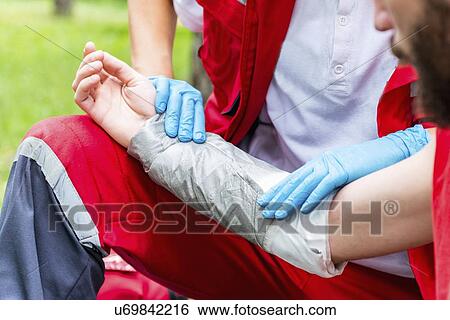 Medical worker treating burns on man's arm View Large Photo Image Stock Photograph - Medical worker treating burns on man's arm. Fotosearch