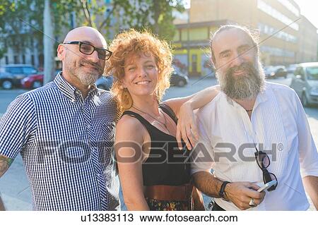 Mid adult woman and male friends on city street, portrait View Large Photo Image Stock Image - Mid adult woman and male friends on city street, portrait. Fotosearch