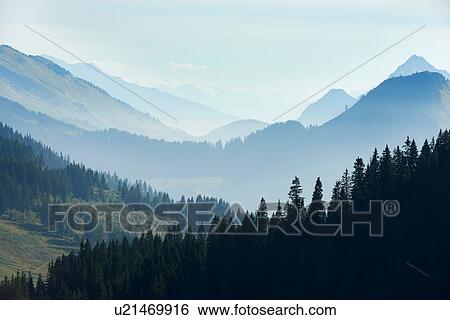 Stock Photograph - Mist over mountain ranges, Manigod, Rhone-Alpes, France. Fotosearch