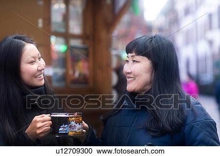 Mother and daughter drinking at Christmas market, Freiburg, Baden-Wurttemberg, Germany View Large Photo Image Stock Image - Mother and daughter drinking at Christmas market, Freiburg, Baden-Wurttemberg, Germany. Fotosearch