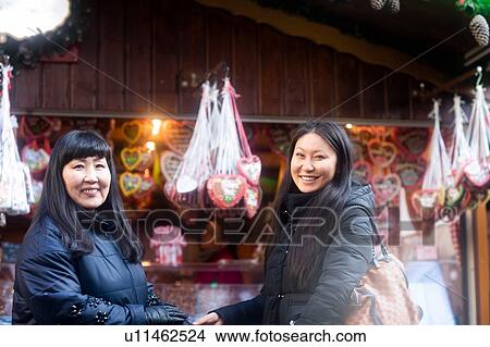Picture - Mother and daughter window shopping at Christmas market, Freiburg, Baden-Wurttemberg, Germany. Fotosearch