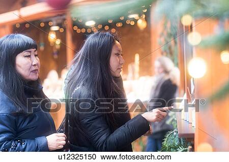 Mother and daughter window shopping at Christmas market, Freiburg, Baden-Wurttemberg, Germany View Large Photo Image Stock Image - Mother and daughter window shopping at Christmas market, Freiburg, Baden-Wurttemberg, Germany. Fotosearch