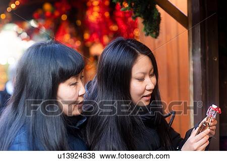 Mother and daughter window shopping at Christmas market, Freiburg, Baden-Wurttemberg, Germany View Large Photo Image Stock Photo - Mother and daughter window shopping at Christmas market, Freiburg, Baden-Wurttemberg, Germany. Fotosearch