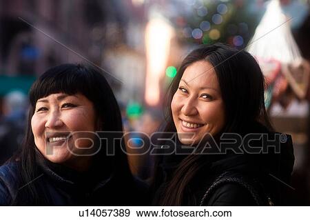 Stock Photo - Mother and daughter window shopping at Christmas market, Freiburg, Baden-Wurttemberg, Germany. Fotosearch