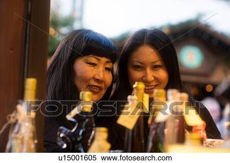 Stock Photography - Mother and daughter window shopping at Christmas market, Freiburg, Baden-Wurttemberg, Germany. Fotosearch