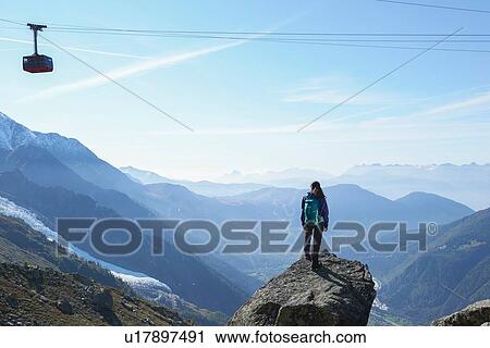 Stock Image - Mountain climber at summit, Chamonix, Rhone-Alps, France. Fotosearch