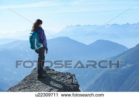 Stock Image - Mountain climber at summit, Chamonix, Rhone-Alps, France. Fotosearch