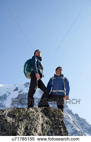 Stock Photography - Mountain climbers enjoying view, Chamonix, Rhone-Alps, France. Fotosearch