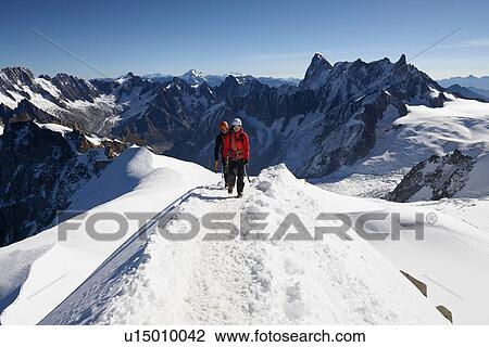 Stock Image - Mountain climbers on snowy trail, Chamonix, Rhone-Alps, France. Fotosearch