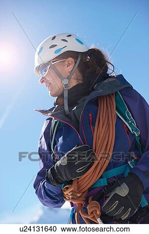 Stock Image - Mountaineer with climbing ropes. Fotosearch