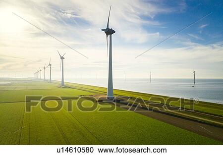 Stock Image - Onshore and offshore wind turbines on reclaimed land, Noordoostpolder, Flevoland, Netherlands. Fotosearch