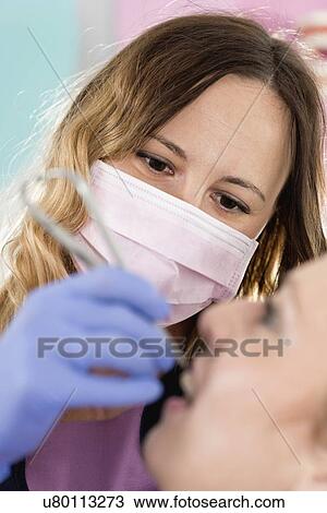 Orthodontist tightening braces View Large Photo Image Stock Image - Orthodontist tightening braces. Fotosearch