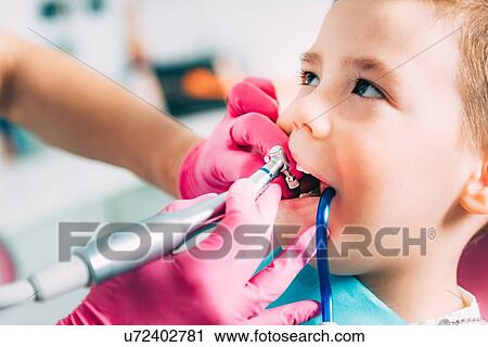 Orthodontist working with little boy. View Large Photo Image Stock Image - Orthodontist working with little boy.. Fotosearch
