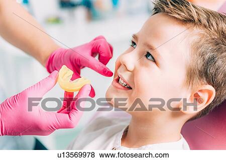 Orthodontist working with little boy. View Large Photo Image Stock Photo - Orthodontist working with little boy.. Fotosearch
