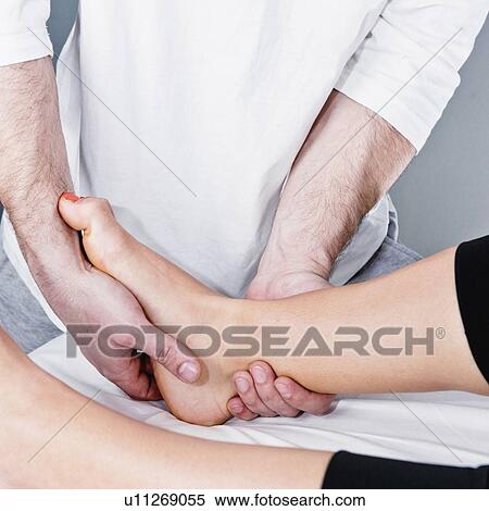 Osteopath working with swollen ankle View Large Photo Image Stock Photography - Osteopath working with swollen ankle. Fotosearch