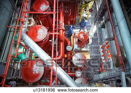 Stock Photograph - Overhead view of engineers in turbine hall of nuclear power station. Fotosearch