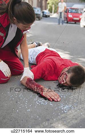 Picture - Paramedic with car accident victim. Fotosearch