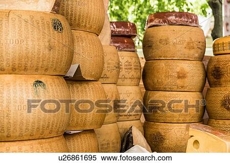 Stock Photography - Parmesan cheese rounds stacked on food stall, Meran, Trentino Alto Adige, Italy. Fotosearch