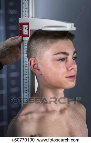 Physical therapist measuring height of teenage boy View Large Photo Image Stock Image - Physical therapist measuring height of teenage boy. Fotosearch