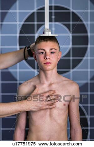 Physical therapist measuring height of teenage boy View Large Photo Image Stock Photography - Physical therapist measuring height of teenage boy. Fotosearch